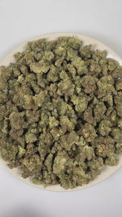 PUFFY Gorilla Butter is a balanced hybrid THCa strain originating from the iconic cross of Gorilla Glue 4 (also known as GG4) and Peanut Butter Breath. The aroma is a potent blend of sticky, glue-like resin, sharp gassy fuel, and fresh, crisp pine. Visually, dense forest green buds with purple hues and fiery orange pistils are coated in sticky trichomes. Consumers often report an euphoric, soothing body relaxation, an uplifted mood, a mild boost in creativity, calmness with a sociable, easygoing vibe. 