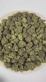PUFFY Wedding Cake is an indica-dominant hybrid THCa strain created by crossing Triangle Cherry Pie and Girl Scout Cookies (GSC). The aroma blends rich creamy sweetness with vibrant fruity notes and a warm, freshly baked doughy finish. Visually, the buds are dense and vibrant, with forest green and purple hues coated in frosty trichomes and bright orange pistils. Consumers often report a euphoric, uplifted mood paired with a relaxing body high, along with a creative and social spark in lighter use. 