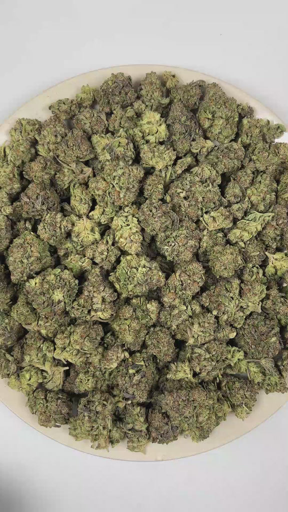 PUFFY Wedding Cake is an indica-dominant hybrid THCa strain created by crossing Triangle Cherry Pie and Girl Scout Cookies (GSC). The aroma blends rich creamy sweetness with vibrant fruity notes and a warm, freshly baked doughy finish. Visually, the buds are dense and vibrant, with forest green and purple hues coated in frosty trichomes and bright orange pistils. Consumers often report a euphoric, uplifted mood paired with a relaxing body high, along with a creative and social spark in lighter use. 