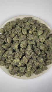 PUFFY Girl Scout Cookies is an Indica-dominant hybrid THCa strain born from the legendary cross of OG Kush and Durban Poison. TThe aroma blends rich, doughy notes with a pungent scent and warm, spicy undertones. Visually, dense forest green buds with purple hues and fiery orange pistils are coated in sticky trichomes. Consumers often report a euphoric high that uplifts the mood, promoting a soothing sense of calm, easing tension, and encouraging a focused mental state.   