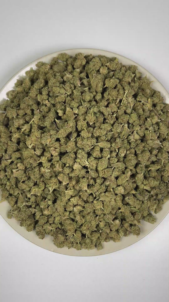 PUFFY Garlic Bud (smalls) is a balanced hybrid THCa strain rooted in the Afghani Indica landrace, known for its traditional Afghan heritage and rich, earthy traits. The aroma features earthy notes complemented by fresh herbal undertones and rich, woody scents. Visually, dense forest green buds with purple hues and fiery orange pistils are coated in sticky trichomes. Consumers often report an initial cerebral uplift with euphoria, elevated mood, and heightened creativity, followed by increased appetite, pote