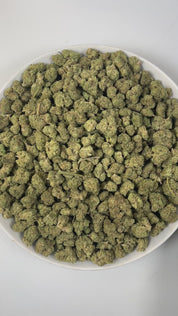 PUFFY Pink Drink (smalls) is a balanced hybrid THCa strain, born from the flavorful cross between Banana Punch × OG Fruit Smoothie. The aroma greets the senses with bright tropical and fruity notes, grounded by subtle earthy undertones. Visually, the dense buds feature bright green and purple hues, accented by orange pistils and a sparkling layer of trichomes. Consumers often report a balanced high, combining uplifting cerebral euphoria with soothing body relaxation, enhanced creativity, focus, sociability,