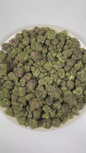 PUFFY Atomic Warhead is a balanced hybrid THCa strain crafted from the exceptional genetics of  Kaboom and Sour Pez. The aroma unfolds with a rich blend of fresh herbal notes, warm spices, and earthy woody undertones. Visually, dense forest green buds with purple hues and fiery orange pistils are coated in sticky trichomes. Consumers often report a euphoric and invigorating cerebral buzz that inspires creativity and sharp focus, gradually complemented by a soothing wave of body relaxation that promotes over