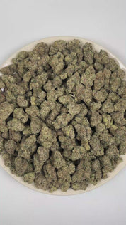 PUFFY Blueberry Caviar is a sativa-dominant hybrid THCa strain, meticulously developed through the cross of Grape Gas and Lantz. The aroma blends sweet, ripe blueberries with creamy, tangy cheese notes and a sharp, savory onion funk for a rich, complex profile. Visually, dense forest green buds with purple hues and fiery orange pistils are coated in sticky trichomes. Consumers often report an uplifting euphoric effect with a strong cerebral mood boost, enhanced creativity and focus, and mild body relaxation