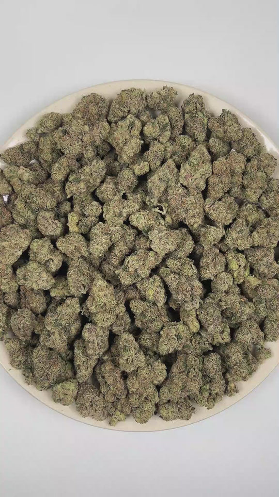 PUFFY Blueberry Caviar is a sativa-dominant hybrid THCa strain, meticulously developed through the cross of Grape Gas and Lantz. The aroma blends sweet, ripe blueberries with creamy, tangy cheese notes and a sharp, savory onion funk for a rich, complex profile. Visually, dense forest green buds with purple hues and fiery orange pistils are coated in sticky trichomes. Consumers often report an uplifting euphoric effect with a strong cerebral mood boost, enhanced creativity and focus, and mild body relaxation