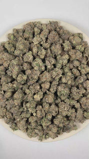 PUFFY Pop Rocks is an indica-dominant THCa strain, a vibrant cross between LA Pop Rocks and Magic Marker. The aroma is a bold blend of pungent fuel notes layered with bright citrus undertones. Visually, dense green buds with purple hues and fiery orange pistils are coated in sticky trichomes. Consumers often report a soothing body high paired with mood enhancement, including feelings of happiness, calm, and mild euphoria, making it ideal for unwinding after a long day. 