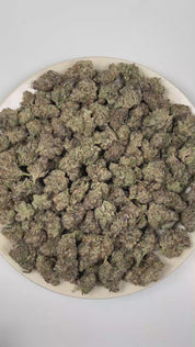 PUFFY First Class Funk is an indica-dominant hybrid THCa strain born from the distinguished cross of GMO × Jet Fuel Gelato. The aroma is defined by smoky intensity, burnt rubber sharpness, and deep musky undertones. Visually, dense deep forest green buds with purple hues and fiery orange pistils are coated in sticky trichomes. Consumers often report a deep, euphoric relaxation that gently washes over the body and mind, easing tension while promoting a calm, blissful state of ease.