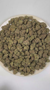 PUFFY Exodus Cheese is a balanced hybrid THCa strain born from the distinct genetic alliance of Skunk #1 (Afghan × Colombian × Mexican landrace genetics). The aroma is bold and unmistakable, unfolding in layers of creamy blue cheese tang, deep funky earthiness, and a sharp, pungent hint of worn, stinky socks. Visually, dense deep forest green buds with purple hues and fiery orange pistils are coated in sticky trichomes. Consumers often report euphoric feelings accompanied by deep relaxation, noticeable stre
