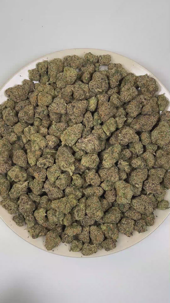 PUFFY Exodus Cheese is a balanced hybrid THCa strain born from the distinct genetic alliance of Skunk #1 (Afghan × Colombian × Mexican landrace genetics). The aroma is bold and unmistakable, unfolding in layers of creamy blue cheese tang, deep funky earthiness, and a sharp, pungent hint of worn, stinky socks. Visually, dense deep forest green buds with purple hues and fiery orange pistils are coated in sticky trichomes. Consumers often report euphoric feelings accompanied by deep relaxation, noticeable stre