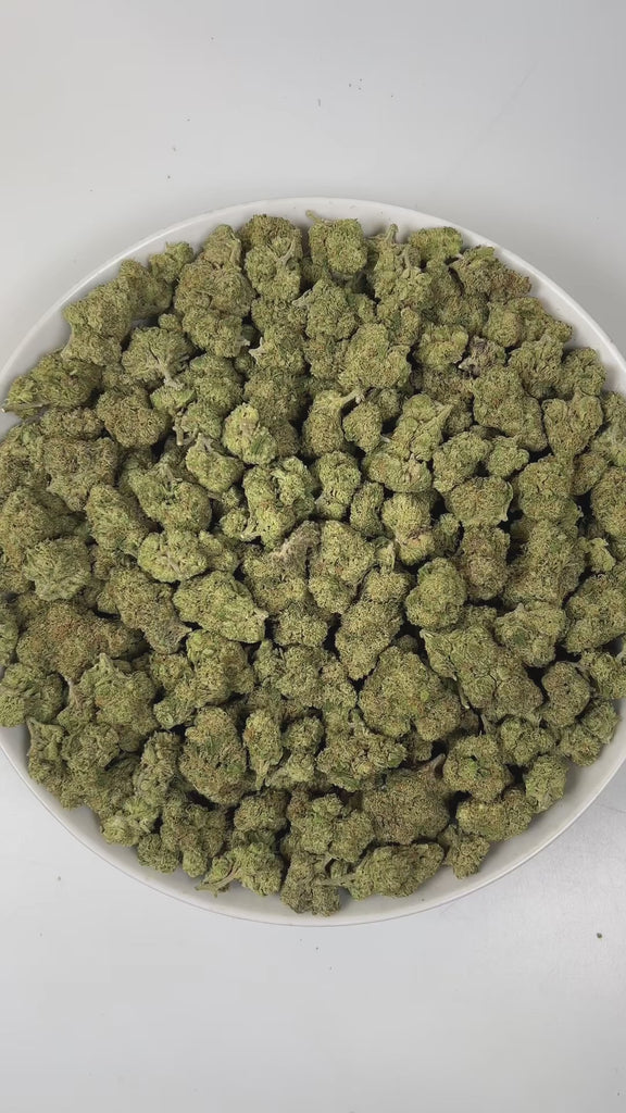 PUFFY Bubba Kush is an indica-dominant hybrid THCa strain, crafted from the legendary lineage of OG Kush × Afghani Indica. The aroma is a lively blend of sweet oranges and ripe berries, underlined by a distinct gassy note, creating a bright, tangy, and slightly pungent scent profile. Visually striking, the buds are dense and resin-packed, shimmering with frosty trichomes over deep green and purple hues accented by bright orange hairs. Consumers often describe the effects as a wave of full-body relaxation th