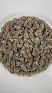 PUFFY Black Matter is an indica-dominant hybrid THCa strain born from the refined cross of Meat Breath and Platinum Icing, further elevated by blending in the potent lineage of Zero Gravity and Oooze. The aroma is a rich, indulgent blend of chocolate and doughy sweetness, underscored by a sharp, gassy punch. Visually, dense forest green buds with purple hues and fiery orange pistils are coated in sticky trichomes. Consumers often report a blissful sense of calm paired with uplifting energy that gradually ea