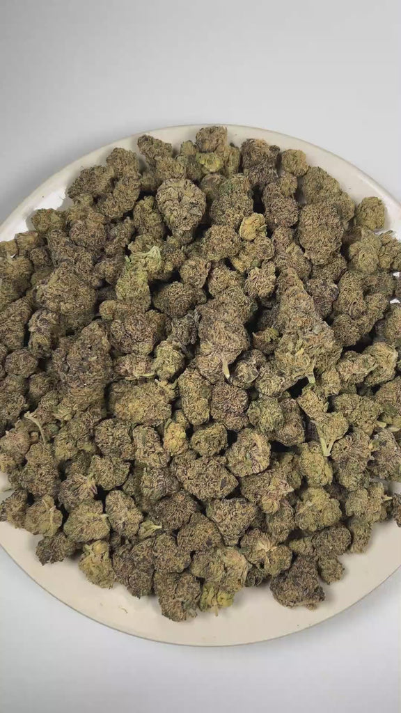PUFFY Cherry Durban Poison is a sativa-dominant hybrid THCa strain cultivated through the deliberate fusion of Cherry Pie × Durban Poison. The aroma blends sweet candy and pungent fuel notes with a smooth pine finish. Visually, dense forest green buds with purple hues and fiery orange pistils are coated in sticky trichomes. Consumers often report feeling euphoric and focused, with an uplifting social energy paired with a calm, mellow feeling. 
