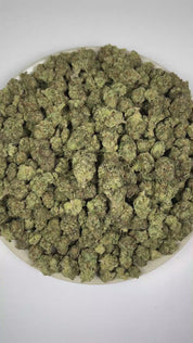 PUFFY White Fire OG is a balanced hybrid THCa strain, crafted from the legendary lineage of Fire OG and The White. The aroma is intensely pungent and gassy, layered with crisp pine notes. Visually, dense forest green buds with hints of purple, bright orange pistils, and a thick coating of sparkling trichomes. Consumers often report a balanced wave of euphoria with uplifting energy, enhanced focus, and a smooth sense of relaxation.