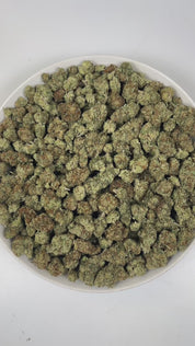 PUFFY Papaya Punch is an indica-dominant hybrid THCa strain crafted from the flavorful union of Papaya and Purple Punch. The aroma is a vibrant blend of tropical sweetness, bursting with ripe papaya and luscious fruity notes that instantly awaken the senses. Visually, the buds are dense and heart-shaped, showcasing a vibrant forest green color accented by fiery orange hairs and a thick, frosty coating of milky amber trichomes. Consumers often report a smooth high, beginning with a gentle cerebral uplift tha