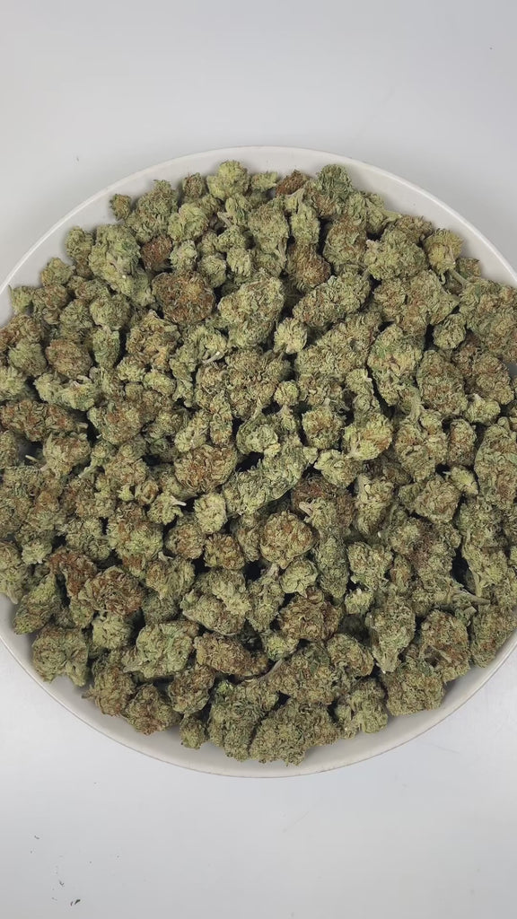 PUFFY Papaya Punch is an indica-dominant hybrid THCa strain crafted from the flavorful union of Papaya and Purple Punch. The aroma is a vibrant blend of tropical sweetness, bursting with ripe papaya and luscious fruity notes that instantly awaken the senses. Visually, the buds are dense and heart-shaped, showcasing a vibrant forest green color accented by fiery orange hairs and a thick, frosty coating of milky amber trichomes. Consumers often report a smooth high, beginning with a gentle cerebral uplift tha