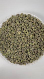 PUFFY Blue Nerdz (smalls) is a balanced hybrid THCa strain, born from the fusion of Forbidden Fruit and Watermelon Z. The aroma is a vibrant blend of sweet blueberries, sharp diesel, and sugary candy, creating a tantalizing and memorable scent experience. Visually, it features compact, bulbous buds in green and deep purple hues, highlighted by orange pistils and a thick frost of trichomes. Consumers often report an uplifting cerebral rush marked by bright euphoria, enhanced mood, and inspired creativity tha