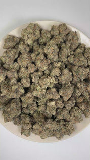 PUFFY French Laundry is a balanced hybrid THCa strain derived from the potent genetic collaboration of The Soap and L.A. Rouge. The aroma is characterized by a bold blend of skunky, fuel-like, and pungent notes, delivering a strong and distinctive profile with an earthy, gassy intensity. Visually, dense forest green buds with purple hues and fiery orange pistils are coated in sticky trichomes. Consumers often report experiencing a euphoric and creative uplift paired with a sense of deep relaxation, calmness