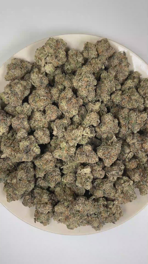 PUFFY French Laundry is a balanced hybrid THCa strain derived from the potent genetic collaboration of The Soap and L.A. Rouge. The aroma is characterized by a bold blend of skunky, fuel-like, and pungent notes, delivering a strong and distinctive profile with an earthy, gassy intensity. Visually, dense forest green buds with purple hues and fiery orange pistils are coated in sticky trichomes. Consumers often report experiencing a euphoric and creative uplift paired with a sense of deep relaxation, calmness