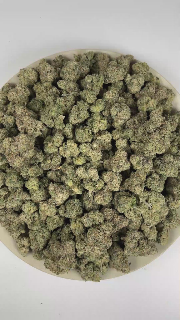 PUFFY Bubblegum is an indica-dominant hybrid THCa strain crafted from the nostalgic Indiana Bubble Gum genetics and a mysterious indica lineage. The aroma is a vibrant blend of fruity and citrus notes, finishing with a subtle fuel-like undertone. Visually, dense spring green buds with purple hues and fiery orange pistils are coated in sticky trichomes. Consumers often report feeling euphoric, blissful, and deeply relaxed, accompanied by an uplifted mood along with a spark of creativity and light cerebral st