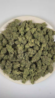 PUFFY Grape Fritter is a balanced hybrid THCa strain derived from the potent genetic collaboration of Grape Ape × Apple Fritter × Jet A. The aroma opens with sweet, juicy berries layered with ripe fruit notes, finishing with a bold, pungent gassy undertone. Visually, dense deep forest green buds with purple hues and fiery orange pistils are coated in sticky trichomes. Consumers often report a euphoric uplift that inspires a creative mindset, promotes a relaxed body sensation, and leaves them feeling calm an