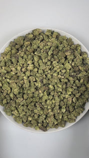 PUFFY Gush Mintz (smalls) is an indica-dominant hybrid THCa strain, born from the cross of Kush Mints × (F1 Durb × Gushers). The aroma greets the senses with a sharp minty freshness, rich cheesy notes, and a bold, pungent undertone. Visually, the buds are dense and striking, showcasing dark green and deep purple hues intertwined with vibrant orange pistils and a sparkling layer of shimmering trichomes. Consumers often describe a powerful, body-zapping high that dissolves stress and tension, leaving the mind