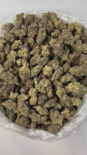 PUFFY Purple Gusher is a well-balanced hybrid THCa strain born from the potent cross between Gelato #41 and Purple Punch. The aroma blends earthy richness with smooth, creamy undertones that entice the senses. Visually, its nugs are dense and chunky, showcasing a vibrant forest-green base laced with deep purple hues, fiery orange pistils, and a heavy dusting of frosty trichomes. Consumers often report an uplifting wave of euphoria and bursts of laughter, followed by a soothing, full-body relaxation. It's a 