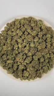 PUFFY Peanut Butter Breath is a balanced hybrid THCa strain bred through the genetic fusion of Do-Si-Dos and Mendo Breath. The aroma is rich and complex, blending smoky undertones with warm cedar and deep earthy notes. Visually, dense deep forest green buds with purple hues and fiery orange pistils are coated in sticky trichomes. Consumers often report feeling euphoric, relaxed, and calm, along with stress relief, full-body relaxation, and an increased appetite.