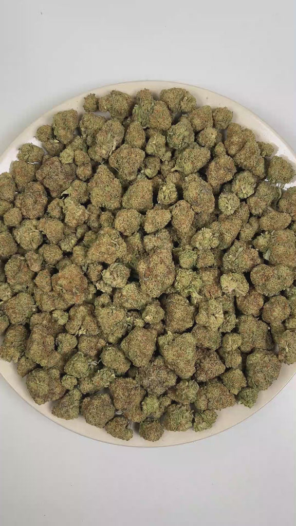 PUFFY Tiramisu is a sativa-dominant hybrid THCa strain, crafted from the decadent union of Wedding Cake and Gelato 45. The aroma is a rich blend of doughy, baked bread-like notes, soft sweetness, and smooth creamy undertones. Visually, dense forest green buds with purple hues and fiery orange pistils are coated in sticky trichomes. Consumers often report a euphoric, uplifted mood paired with bursts of energy, enhanced creativity, and focused mental clarity. 