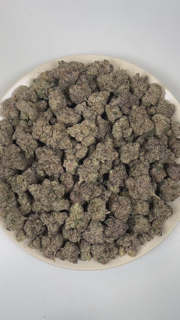 PUFFY Purple Pez is a balanced hybrid THCa strain created through the indulgent cross of Purple Punch and Candy Kush. The aroma delivers a bold fusion of ripe grape, sweet candy-like notes, and sharp gasoline fuel undertones. Visually, dense forest green buds with purple hues and fiery orange pistils are coated in sticky trichomes. Consumers often report an initial euphoric and happy mental uplift with enhanced creativity, followed by a gently relaxing body high that promotes calmness.