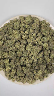 PUFFY Jelly Donut is an indica-dominant hybrid THCa strain born from the fusion of Girl Scout Cookies and King Louis XIII. The aroma opens with a lush burst of ripe berries, followed by a smooth, creamy undertone that softens the profile, while bright tropical notes add a juicy, sun-ripened character. Visually, the buds are dense, with deep forest green and purple tones, bright orange pistils, and a frosty trichome coating. Consumers commonly describe an uplifting, mood-enhancing high that starts with a wav