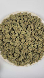 PUFFY Hustler Fuel is a balanced hybrid THCa strain lineage believed to stem from OG Kush and a Diesel/Chemdawg-descended hybrid (not officially verified). The aroma opens with funky savory notes and earthy garlic undertones, followed by a pungent intensity and sharp fuel-like character. Visually, dense forest green buds with purple hues and fiery orange pistils are coated in sticky trichomes. Consumers often report an uplifting euphoric buzz paired with enhanced focus, heightened mental clarity, and a deep
