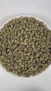 PUFFY Hood Candy (smalls) is an indica-dominant hybrid THCa strain created through the dynamic cross of Runtz and Why U Gelly. The aroma is a bold blend of onions, diesel, and chemicals, with a sharp, intense edge. Visually, dense forest-green buds with hints of purple are threaded with fiery orange pistils and coated in a sparkling layer of sticky trichomes. Consumers often report feeling euphoric and deeply relaxed, with an overall sense of uplifted mood and positivity.