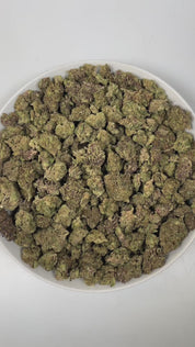 PUFFY Fruity Pebbles is an indica-dominant hybrid THCa strain, born from the intricate cross of Green Ribbon × Granddaddy Purple x Tahoe Alien. The aroma of this strain is a captivating blend of fruity sweetness, subtle licorice notes, and warm, aromatic spices, creating a complex and inviting scent profile that entices the senses. Visually, dense green buds with purple hues and fiery orange pistils are coated in sticky trichomes. Consumers often report a blissful blend of happiness and euphoria, feeling up
