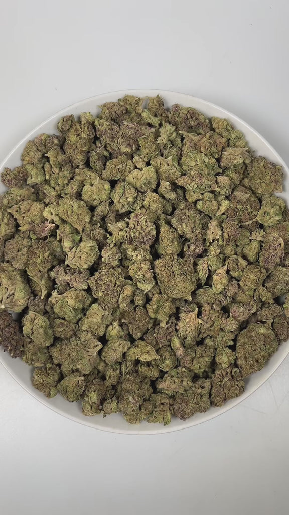 PUFFY Fruity Pebbles is an indica-dominant hybrid THCa strain, born from the intricate cross of Green Ribbon × Granddaddy Purple x Tahoe Alien. The aroma of this strain is a captivating blend of fruity sweetness, subtle licorice notes, and warm, aromatic spices, creating a complex and inviting scent profile that entices the senses. Visually, dense green buds with purple hues and fiery orange pistils are coated in sticky trichomes. Consumers often report a blissful blend of happiness and euphoria, feeling up