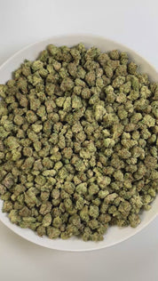 PUFFY GMO x OZK (smalls) is an indica-dominant hybrid THCa strain, born from the legendary cross between GMO (Garlic Cookies) and OZ Kush (OG Kush x Zkittlez). The aroma is distinctly gassy, delivering a sharp, pungent scent that immediately commands attention. Visually striking, the buds are dense, with deep greens and purples glinting beneath a frosty layer of trichomes. Consumers often report a deep, soothing body relaxation paired with a blissful, uplifting mental high.
