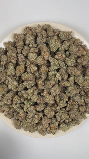 PUFFY Blueberry Pie is an indica-dominant hybrid THCa strain originating from the iconic cross of Blue Dream and Girl Scout Cookies. The aroma is pungent and unmistakably bold, blending sweet blueberries with a rich, savory cheese undertone. Visually, dense forest green buds with purple hues and fiery orange pistils are coated in sticky trichomes. Consumers often report an initial euphoric, uplifting head high that gradually settles into a deeply relaxed body high that may help ease stress, anxiety, and ins