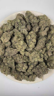 PUFFY Donkey Butter is an indica-dominant hybrid THCa strain formulated through the selective pairing of Kosher Kush and Tangie. The aroma opens with bold diesel fumes layered over rich skunky earthiness, finishing with a deeply pungent intensity. Visually, dense forest green buds with purple hues and fiery orange pistils are coated in sticky trichomes. Consumers often report an uplifting wave of euphoria accompanied by a mild cerebral boost that promotes an elevated mood, followed by deep body relaxation a