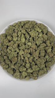 PUFFY Triangle Kush is an indica-dominant hybrid THCa strain, born from a powerful cross between Florida OG Kush and Hindu Kush. The aroma bursts with zesty lime notes, grounded by earthy undertones and a bold, pungent finish that lingers enticingly. Visually, dense deep green buds with purple hues and fiery orange pistils are coated in sticky trichomes. Consumers frequently describe effects that begin with a calming body sensation that helps ease stress and anxiety, followed by an uplifting cerebral high t