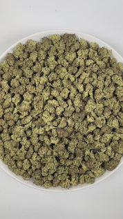 PUFFY Ice Cream Cake (smalls) is an Indica-dominant hybrid THCa strain, born from the potent cross between Wedding Cake and Gelato #33. The aroma is a luscious blend of creamy, vanilla, and fruity notes that immediately delights the senses. Visually, its buds are dense and chunky, showcasing a vibrant mix of green and purple hues with occasional touches of lavender, accented by fiery orange pistils. Consumers often report an experience that begins with a euphoric, uplifting cerebral high, gradually 
easing 