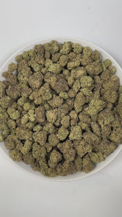 PUFFY Bolato is an indica-dominant hybrid THCa strain, expertly crafted from a premium blend of Curelato, Runtz, and Lemon Cherry Gelato. The aroma is a rich blend of herbal, woody, and smokey notes, creating a deep, earthy scent that lingers pleasantly in the air. Visually, dense green buds with purple hues and fiery orange pistils are coated in sticky trichomes. Consumers often report a euphoric and deeply relaxing experience that helps reduce stress while potentially easing both anxiety and physical disc