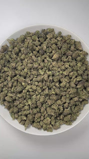 PUFFY White Truffle (smalls) is an indica-dominant hybrid THCa strain, crafted from the legendary lineage of Gorilla Butter, a standout phenotype of Gorilla Glue #4 × Peanut Butter Breath. The aroma is rich and inviting, with doughy undertones layered over an earthy base and a distinctly pungent finish that lingers pleasantly in the air. Visually striking, these medium-sized buds glisten under a thick frost of white trichomes, with vibrant orange pistils winding through deep green and purple tones. Consumer