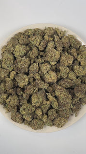 PUFFY Grease Gun is a balanced hybrid THCa strain crafted from the distinctive pairing of Gorilla Glue and Mythic OG. The aroma is a rich blend of earthy, herbal, and woody notes, evoking the calming essence of a serene forest after a fresh rain. Visually, dense green buds with purple hues and fiery orange pistils are coated in sticky trichomes. Consumers often report a euphoric, creative, and focused high that leaves them feeling uplifted, social, and lightly relaxed.