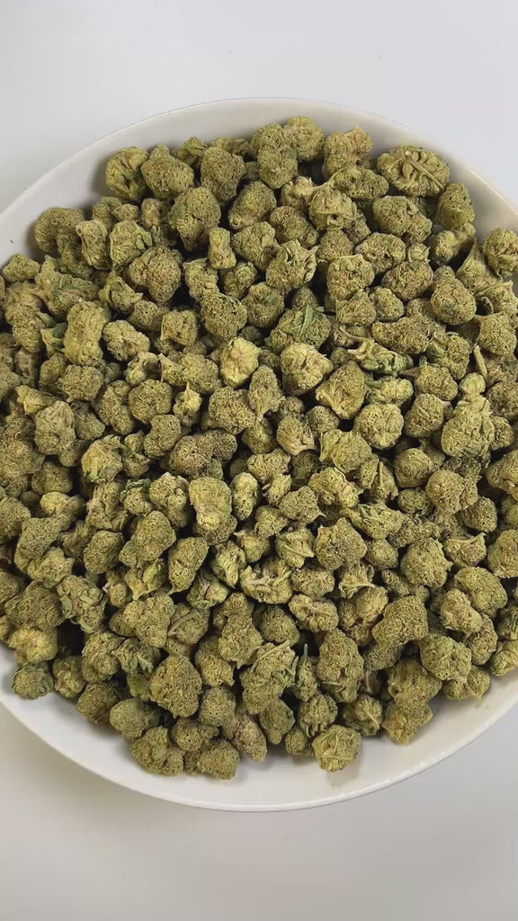 PUFFY Citrus Kush is an indica-dominant  hybrid THCa strain, widely believed to be a cross of Master Kush with a citrus-forward strain, though its true parentage remains uncertain and varies by source. The aroma hits with sharp bursts of lemon layered over deep, tarry notes and a bold hint of asphalt, creating a strikingly intense profile. Visually, the buds are dense and compact, showcasing deep forest-green hues highlighted by vivid yellow-orange pistils and a heavy frost of shimmering trichomes. Consumer