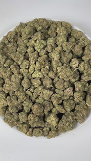 PUFFY Blueberry ZKZ is an indica-dominant hybrid THCa strain, crafted from the legendary lineage of Blueberry × ZKZ. The aroma blends sweet berry and candy notes with a bold, fuel-like edge, creating a strikingly sweet yet gassy scent profile. Visually, the buds are dense with subtle blue hues, vibrant orange pistils, and a thick, shimmering coating of frosty trichomes. Consumers often report an uplifted mood and creative spark accompanied by a relaxing, mellow body effect, with increased appetite.
