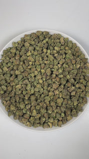 PUFFY Permanent Marker (smalls) is an indica-dominant hybrid THCa strain, born from the complex cross of Biscotti, Jealousy, and Sherbet BX. The aroma is a rich blend of herbal notes layered with warm spices, highlighted by distinct hints of licorice and clove. Visually striking, the buds feature deep purple and green hues, bright orange pistils, and a thick coating of sparkling resinous trichomes. Consumers often report a blissful euphoria that uplifts the mood, sparks creativity, creates gentle tingling s