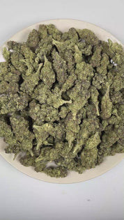 PUFFY Girl Scout Cookies is an Indica-dominant hybrid THCa strain born from the legendary cross of OG Kush and Durban Poison. The aroma opens with rich nutty notes layered with warm, freshly baked dough, finishing with a smooth, sweet cake-like essence. Visually, dense forest green buds with purple hues and fiery orange pistils are coated in sticky trichomes. Consumers often report a euphoric high that uplifts the mood, promoting a soothing sense of calm, easing tension, and encouraging a focused mental sta
