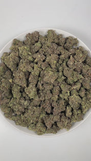 PUFFY Jokerz Candy is an indica-dominant hybrid THCa strain, born from the flavorful cross between Gummiez and Grape Gasoline. The aroma is a vivid blend of sweet rainbow candy, sharp diesel, and pungent gasoline, creating a bold and enticing scent that immediately captures attention. Visually, the dense buds display forest-green tones with deep purple hues, vibrant orange pistils, and a frosty trichome coating. Consumers often describe the effects as euphoric and uplifting, promoting happiness and mental c