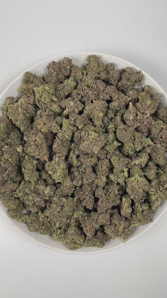 PUFFY Jokerz Candy is an indica-dominant hybrid THCa strain, born from the flavorful cross between Gummiez and Grape Gasoline. The aroma is a vivid blend of sweet rainbow candy, sharp diesel, and pungent gasoline, creating a bold and enticing scent that immediately captures attention. Visually, the dense buds display forest-green tones with deep purple hues, vibrant orange pistils, and a frosty trichome coating. Consumers often describe the effects as euphoric and uplifting, promoting happiness and mental c