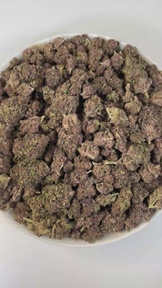 PUFFY Tropical Cherry is a sativa-dominant hybrid THCa strain, typically bred by crossing Tropicana Cookies with Cherry Cookies. The aroma bursts with sweet, fruity notes layered with juicy, tropical richness, creating an inviting and refreshing scent. Visually, the buds are dense and oversized, showcasing deep purple and green tones accented by bright orange pistils and a frosty trichome layer. Consumers often report a vibrant, uplifting high that boosts mood, sparks creativity, and enhances focus while of